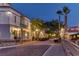 Charming cobblestone street lined with shops and golf carts at night at 1294 Harbor Ridge Dr, Kissimmee, FL 34759