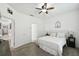 Main bedroom with king-size bed, ceiling fan, and access to a bathroom and hallway at 1294 Harbor Ridge Dr, Kissimmee, FL 34759