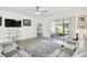 Relaxing living room with gray reclining sofas and access to backyard at 1294 Harbor Ridge Dr, Kissimmee, FL 34759