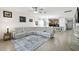 Open concept living room and kitchen with tile floors and a large sectional sofa at 1294 Harbor Ridge Dr, Kissimmee, FL 34759