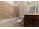 Clean bathroom with tub, toilet, and dark brown vanity at 794 Citrus Isle Dr, Davenport, FL 33837