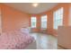 Bright bedroom with light peach walls and tile flooring at 794 Citrus Isle Dr, Davenport, FL 33837