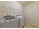 Laundry room with washer, dryer, and overhead shelving at 794 Citrus Isle Dr, Davenport, FL 33837