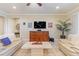 Spacious living room featuring comfortable sofas, a large TV, and a beautiful wooden cabinet at 341 Navarra Ln, Davenport, FL 33837