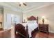 Main bedroom with a king-size bed, hardwood floors, and en-suite bathroom at 341 Navarra Ln, Davenport, FL 33837