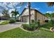 Two-car garage with side yard landscaping and paver driveway at 341 Navarra Ln, Davenport, FL 33837