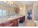 Elegant bathroom with double vanity, large mirror, and access to walk-in closet at 341 Navarra Ln, Davenport, FL 33837