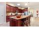 Gourmet kitchen boasting rich wood cabinets, granite countertops, and a sizable island at 341 Navarra Ln, Davenport, FL 33837