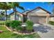 One-story house with a two-car garage and well-manicured lawn at 341 Navarra Ln, Davenport, FL 33837