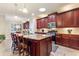 Spacious kitchen with an island, granite countertops, and dark wood cabinets at 341 Navarra Ln, Davenport, FL 33837
