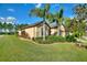 Landscaped yard with mature palm trees and well-maintained lawn at 341 Navarra Ln, Davenport, FL 33837