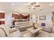 Spacious living room with light beige couches and a large stone coffee table at 341 Navarra Ln, Davenport, FL 33837