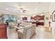 Open living room with a view into a kitchen and access to a patio at 341 Navarra Ln, Davenport, FL 33837