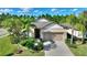 One-story house with a two-car garage and well-maintained landscaping at 341 Navarra Ln, Davenport, FL 33837