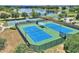 Aerial view of community tennis courts with blue and green surfaces at 341 Navarra Ln, Davenport, FL 33837