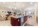 Open-concept kitchen with a large island, stainless steel appliances, and ample counter space at 341 Navarra Ln, Davenport, FL 33837