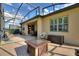 Large screened patio with fire pit and outdoor furniture at 341 Navarra Ln, Davenport, FL 33837