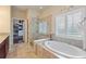 Luxurious bathroom with a soaking tub, walk-in shower, and double vanity at 341 Navarra Ln, Davenport, FL 33837