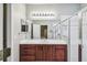 Bathroom features dark wood vanity, a large mirror, and a shower at 123 Gulf Dr, Kissimmee, FL 34759