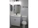 Modern bathroom with white vanity, black fixtures, and gray flooring at 411 Gannet Ct, Kissimmee, FL 34759