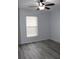 Bright bedroom with wood-look floors and ceiling fan at 411 Gannet Ct, Kissimmee, FL 34759