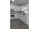 Updated kitchen boasting white cabinets, new appliances, and vinyl flooring at 411 Gannet Ct, Kissimmee, FL 34759