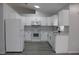 Modern kitchen featuring white cabinets, new appliances, and quartz countertops at 411 Gannet Ct, Kissimmee, FL 34759