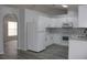 Bright kitchen with white cabinets, stainless steel appliances, and vinyl flooring at 411 Gannet Ct, Kissimmee, FL 34759