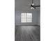 Living room with gray vinyl flooring and a ceiling fan at 411 Gannet Ct, Kissimmee, FL 34759