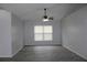 Spacious living room with gray vinyl flooring and a ceiling fan at 411 Gannet Ct, Kissimmee, FL 34759