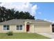 Single-story home with a red door and attached garage at 411 Gannet Ct, Kissimmee, FL 34759