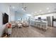 Open-concept kitchen with island, stainless steel appliances, and white cabinets at 872 Sydney St, Davenport, FL 33837