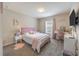 Bright bedroom with a pink theme, vanity, and wall-mounted TV at 872 Sydney St, Davenport, FL 33837
