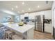 Modern kitchen with white cabinets, quartz countertops, and stainless steel appliances at 872 Sydney St, Davenport, FL 33837