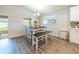 Dining area with table, bench seating, and wood-look floors at 872 Sydney St, Davenport, FL 33837
