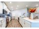 Modern kitchen with white cabinets, stainless steel appliances, and an island at 872 Sydney St, Davenport, FL 33837