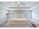 Spacious main bedroom with plush carpeting, a ceiling fan, and large windows at 872 Sydney St, Davenport, FL 33837