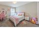 Bright bedroom with pink and white bedding, and a vanity area at 872 Sydney St, Davenport, FL 33837