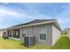 Side view showcasing the home's solar panels and screened patio at 872 Sydney St, Davenport, FL 33837