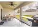 Covered patio with outdoor dining set and grill at 872 Sydney St, Davenport, FL 33837
