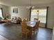 Dining area with a wooden table and chairs, adjacent to a living area at 1652 Dunes Ct, Haines City, FL 33844