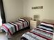 Bright bedroom with two twin beds and wood-look floors at 1652 Dunes Ct, Haines City, FL 33844