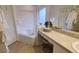 Bathroom with corner bathtub, vanity, and mirror at 1652 Dunes Ct, Haines City, FL 33844