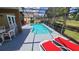 Screened pool and patio with lounge chairs and table at 1652 Dunes Ct, Haines City, FL 33844