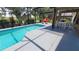 Enclosed pool area with patio furniture and golf course view at 1652 Dunes Ct, Haines City, FL 33844