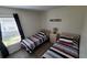 Bedroom with two twin beds and a dresser at 1652 Dunes Ct, Haines City, FL 33844