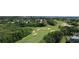 Aerial view of a golf course community with houses and lush green landscape at 1652 Dunes Ct, Haines City, FL 33844