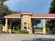 Gated community entrance with a guardhouse and landscaping at 1652 Dunes Ct, Haines City, FL 33844