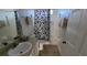 Clean bathroom with a tub shower and black and white floral curtain at 1652 Dunes Ct, Haines City, FL 33844