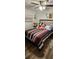 Bedroom with a striped comforter and Mickey Mouse plushies at 4768 Walden Cir # 327, Orlando, FL 32811
